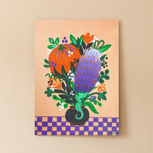 Image shows a painted canvas completed using the Arty Party Kits 'Aussie Bouquet' acrylic painting kit for beginners. It features a vase full of native Australian plants on a checkerboard tablecloth. The colour palette is peach, orange, green, purple and accents of black and white.